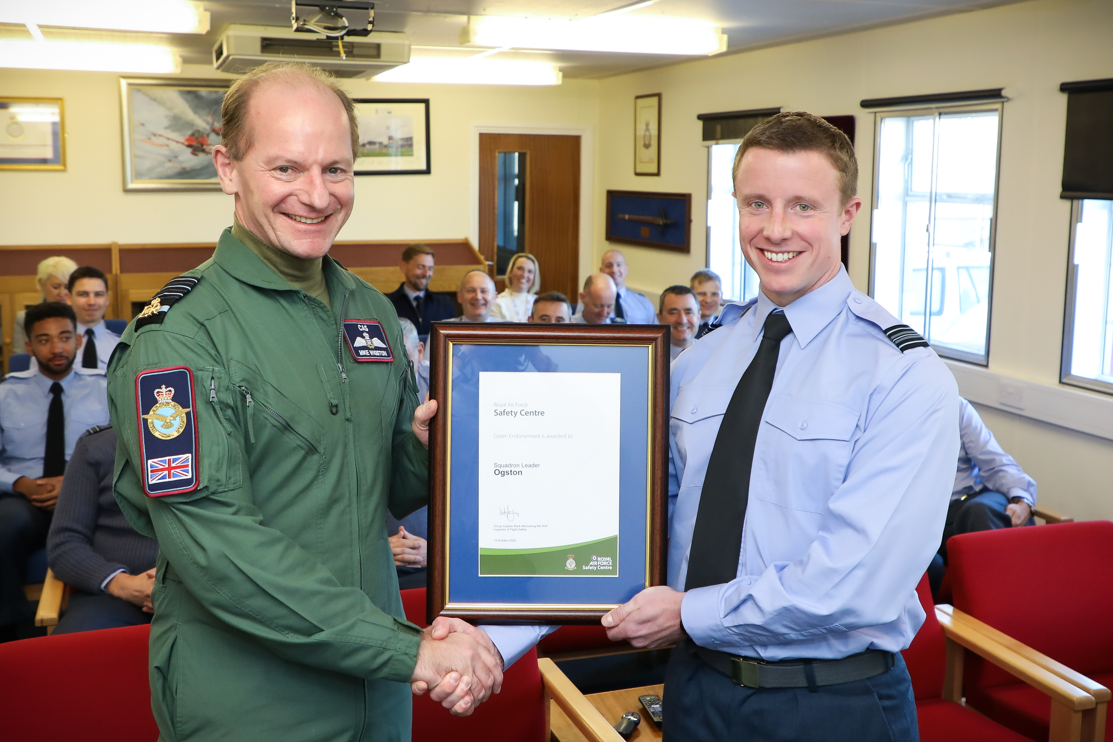 Chief of the Air Staff, Air Chief Marshal Sir Mike Wigston, left, presents the award to Squadron Leader Gregor Ogston at RAF Waddington.